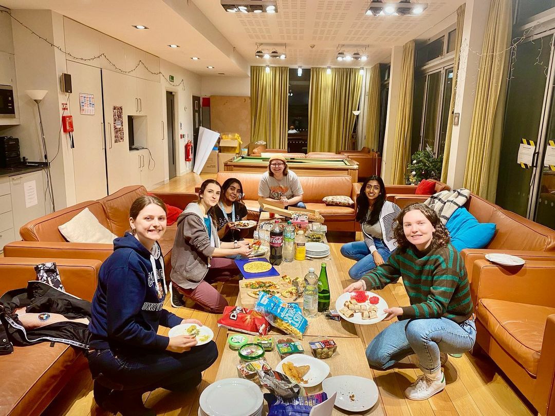 Postgraduates in the MCR at a potluck dinner for 'Veganuary'.